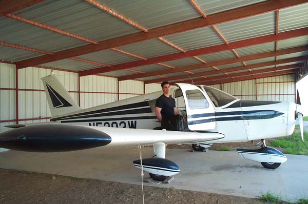 dennis maust frames mike with his piper cherokee in the hangar
